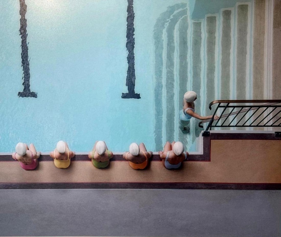 SOO BURNELL "SYNCHRONISED SWIM TEAM MOLITOR" PHOTOGRAPH SIGNED ON VERSO: A photograph print depicting an aerial view of a swimming pool with six figures wearing bathing caps near the edge and stairs leading into the water on the right. Dimensions: 24"L x 28"W Artis