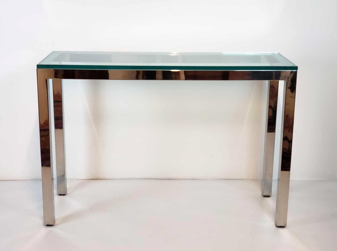 MID CENTURY CHROME GLASS TOP CONSOLE TABLE IN THE STYLE OF LEE ROSEN / PACE: *A beautiful executed rectangular console table with a thick glass top resting on a highly polished, square tubular chrome frame. Dimensions: 34"H x 50"W x 17"D Maker: Unknown Provenanc