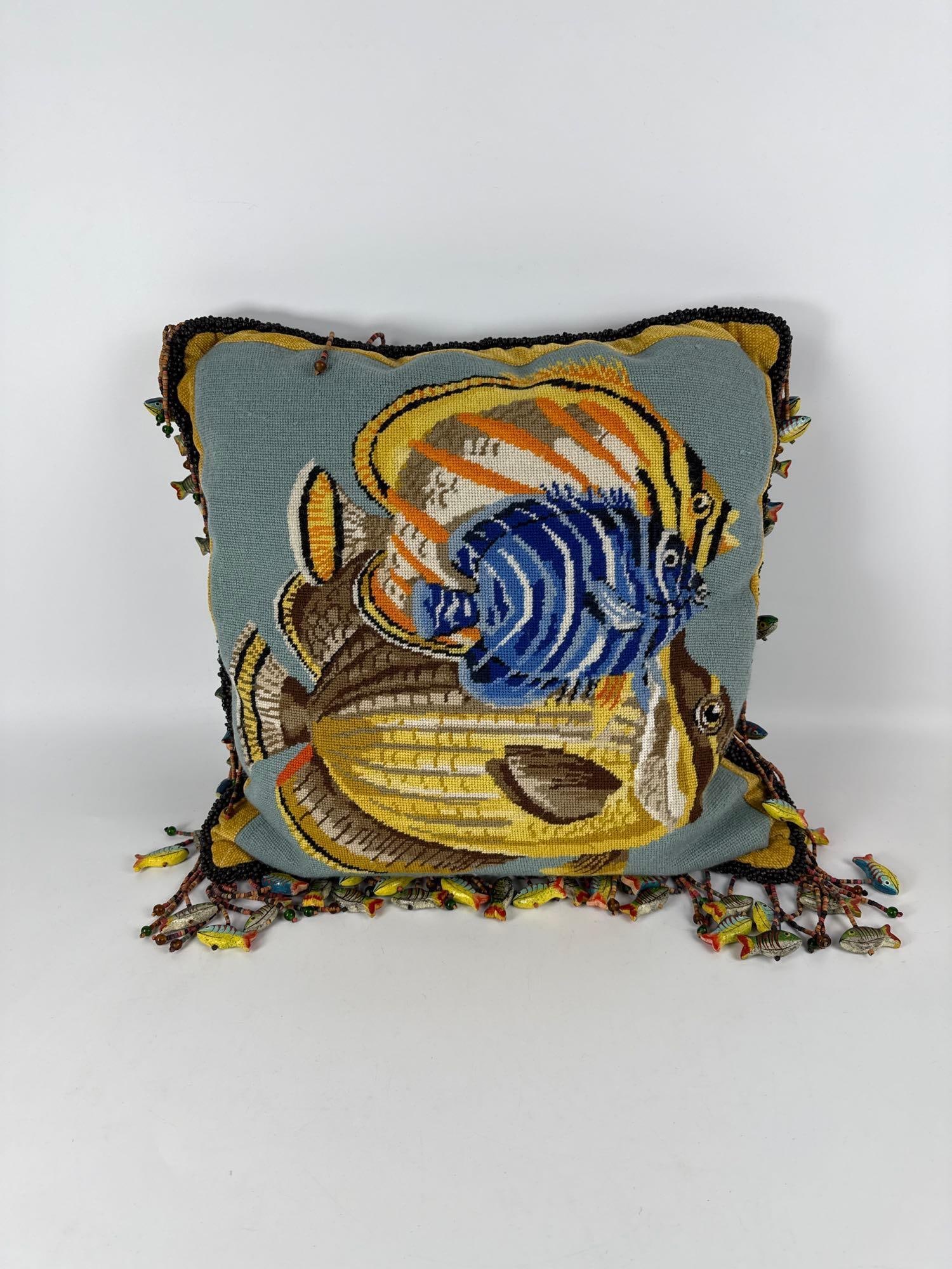 NEEDLEPOINT PILLOW OF AQUATIC SCENE W/DECORATIVE WOODEN BEADED FISH: A handmade pillow with an undersea theme. Dimensions: 16” x 16” Maker: Unknown Provenance: The Estate of Joseph Rodano Notes: Although care is taken to photograph and describe t