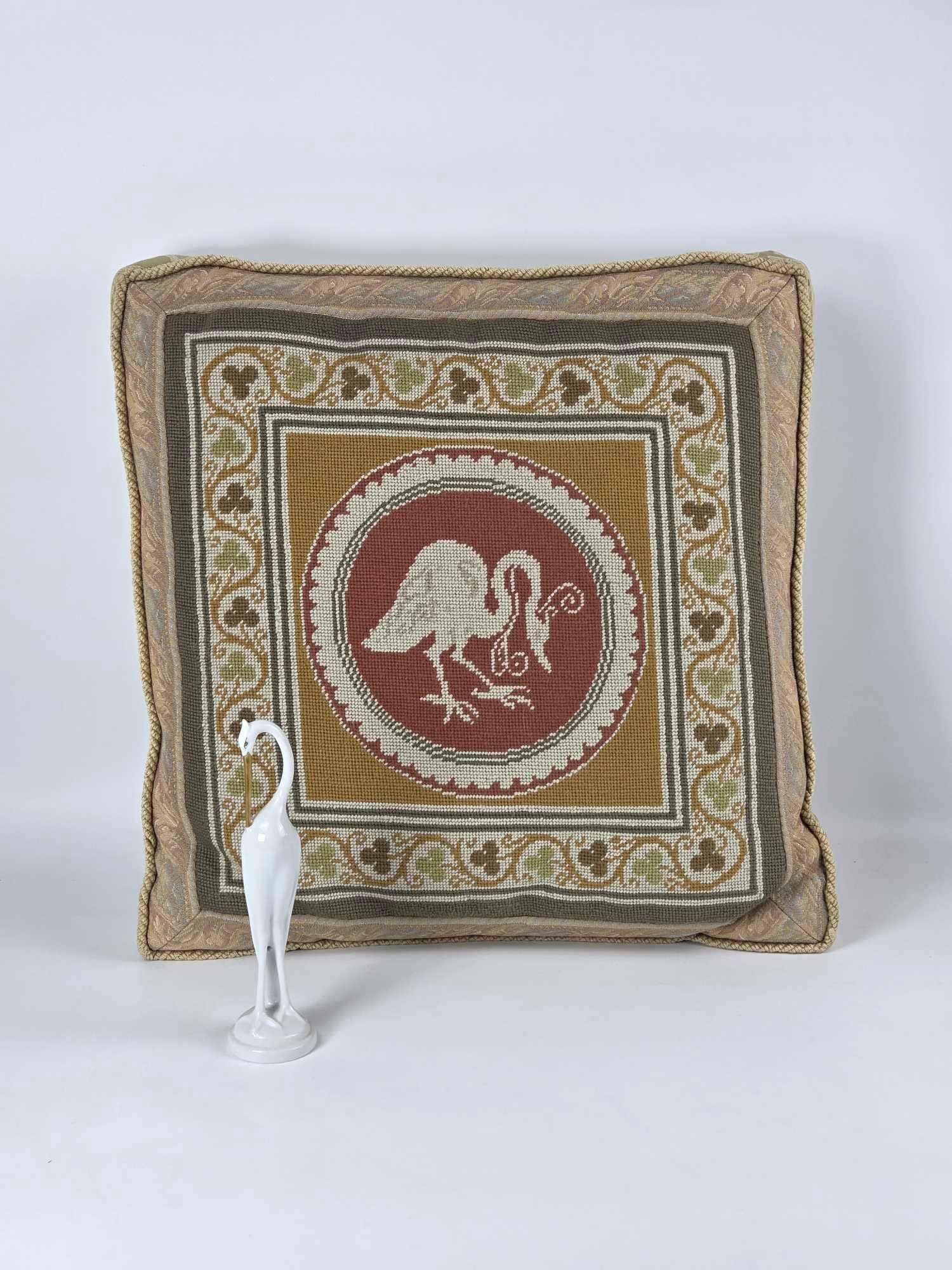 VINTAGE NEOCLASSICAL STYLE CRANE MOTIF NEEDLEPOINT PILLOW AND FINE PORCELAIN CRANE: A handmade pillow with a Crane theme with a coordinating figurine. Dimensions: PILLOW 19" X 19" CRANE 8"H Maker: Unknown Provenance: The Estate of Joseph Rodano Notes: