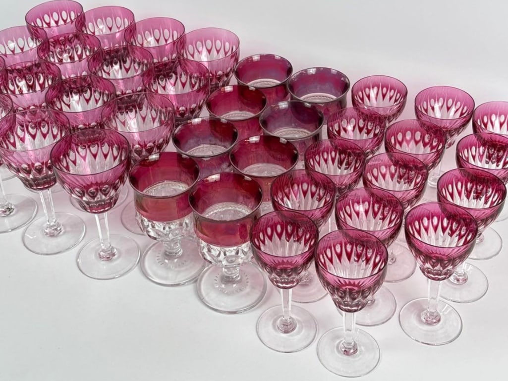 SET OF 29 VAL ST. LAMBERT CRANBERRY & 8 CUT-TO-CLEAR CRYSTAL STEMWARE LOT OF 37 PIECES: This lot contains a large set of 29 Val St. Lambert cut crystal and 8 glass wine glasses and goblets in a vivid cranberry color. Dimension: 6.5" h x 3.25" dia Artist/Maker: Unknown Provenance: A N