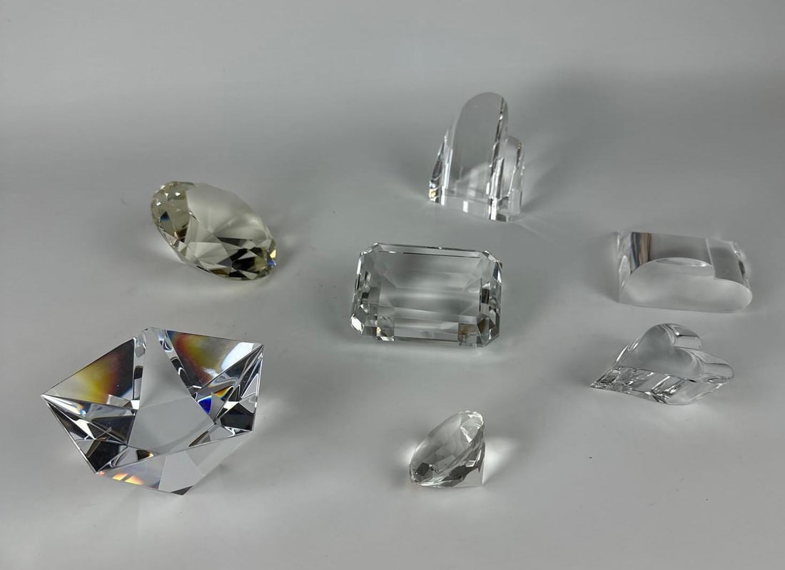 MIXED STEUBEN LOT - HEARTS AND DIAMONDS GEMSTONE-SHAPED CRYSTAL PAPERWEIGHTS LOT: This lot contains a collection of six high-quality clear crystal paperweights in assorted shapes, including genuine Steuben pieces. Dimensions of Largest: 2”h x 4”w x 4”d Provenance