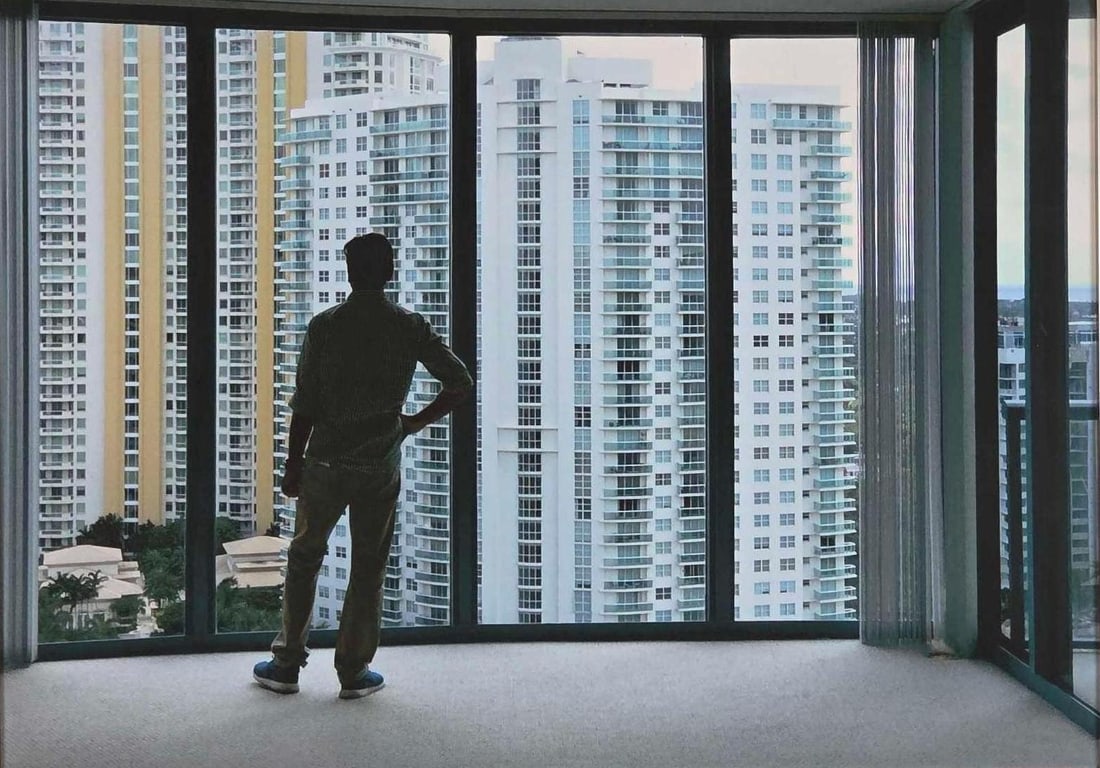 LARGE FRAMED PHOTO OF A MAN LOOKING OUT A WINDOW (OVERLOOKING MIAMI?) (1 of 8)