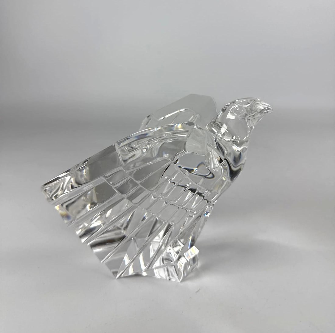 DONALD POLLARD FOR STEUBEN AMERICAN EAGLE CRYSTAL FIGURE, 1975 #8304: A clear, cut crystal glass sculpture of an American eagle poised for flight, designed by Donald Pollard for Steuben Glass in 1975. Approximate Dimensions: 6.5" T Artist or Maker: Donald Polard fo