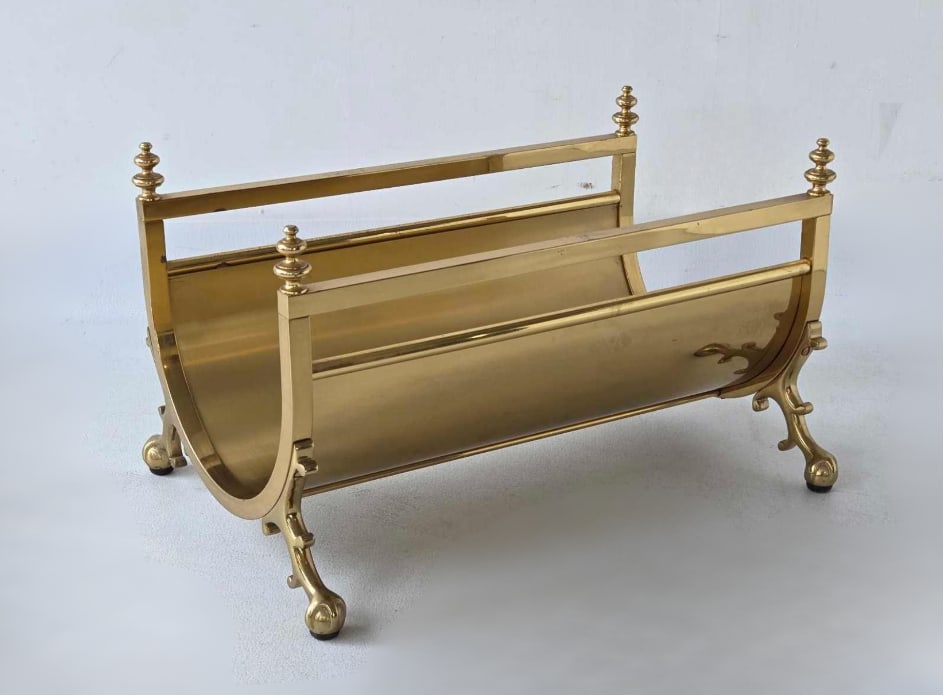 VINTAGE HOLLYWOOD REGENCY MAISON JANSEN STYLE SOLID BRASS LOG HOLDER: A decorative brass log holder with ball and claw feet. Approximate Dimensions:13.5" h x 22.75"w x 16"d Artist or Maker: Unknown Provenance: From a New York Collector</