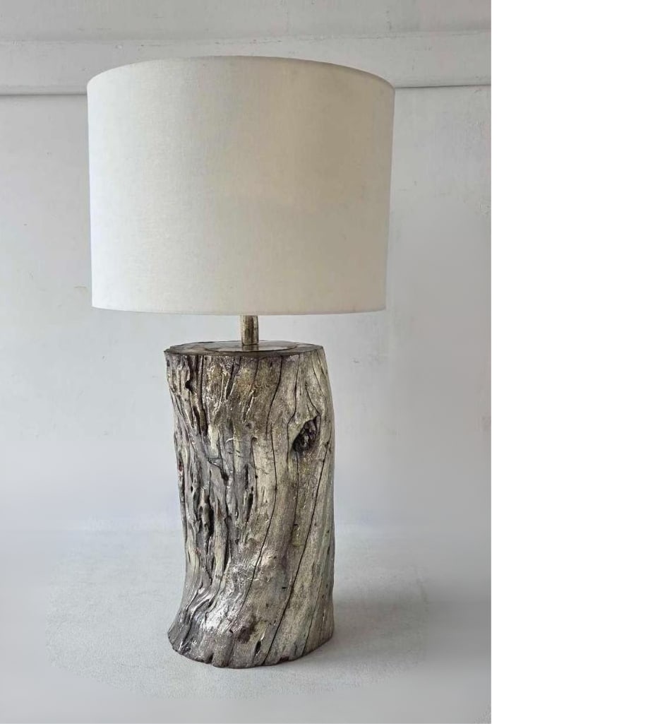VINTAGE SILVER-GILT CARVED WOOD 'LOG' TABLE LAMP: This is a wood table lamp finished in a distressed silver leaf or silver gilt. Approximate Dimensions:36"h inc. harp. Log: 19"h x 11"dia Artist or Maker: Unknown Provenance: From a New Yo