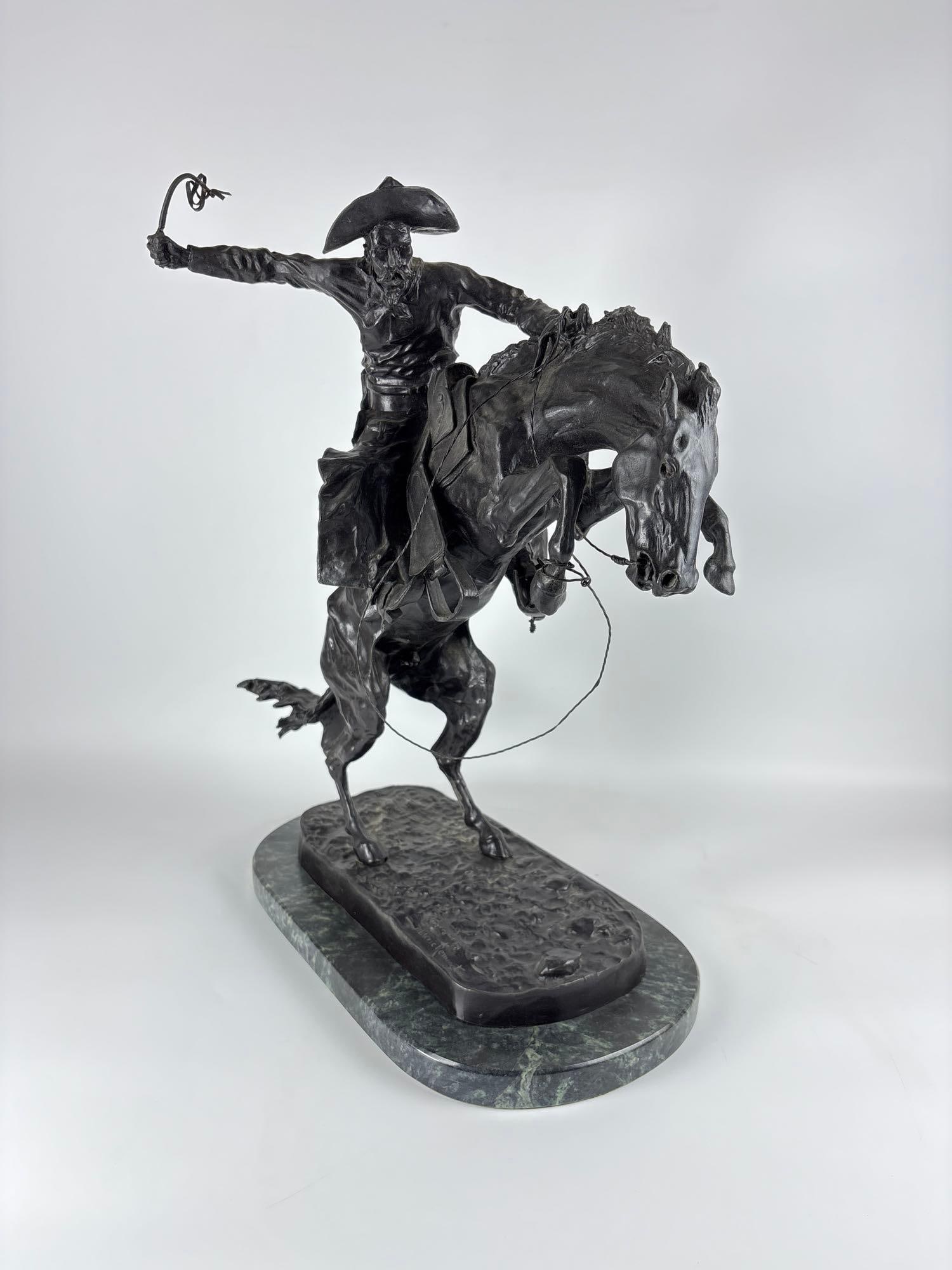FREDERIC REMINGTON "BRONCO BUSTER" BRONZE SCULPTURE: Large-scale cast bronze statue of a cowboy taming a rearing horse mounted on a marble plinth base. Approximate Dimensions: 24”H x 22"L x 12”W Artist or Maker: Frederick Remington Proven