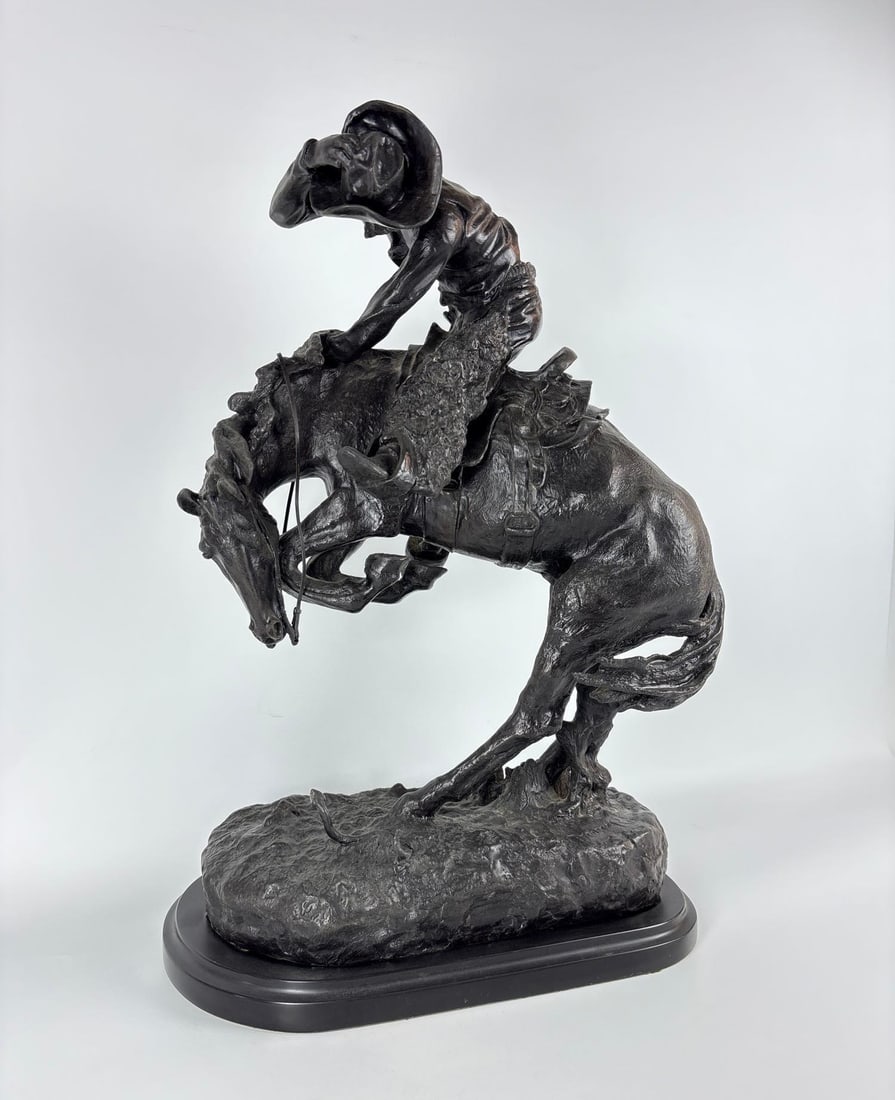 FREDERIC REMINGTON "THE RATTLESNAKE" LARGE BRONZE SCULPTURE 24": Dynamic patinated bronze casting of a cowboy on a bucking horse recoiling from a snake on a naturalistic base. Approximate Dimensions: 24.5" x 16" x 9.5" Artist or Maker: Remington Provenance: From