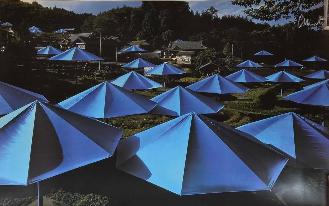 CHRISTO SIGNED PHOTO "THE UMBRELLAS, JAPAN-USA": Limited edition color photograph documenting the 1991 environmental art installation in Ibaraki, Japan, hand-signed by the artist. Approximate Dimensions: 24" x 39" Artist or Maker: Christo,
