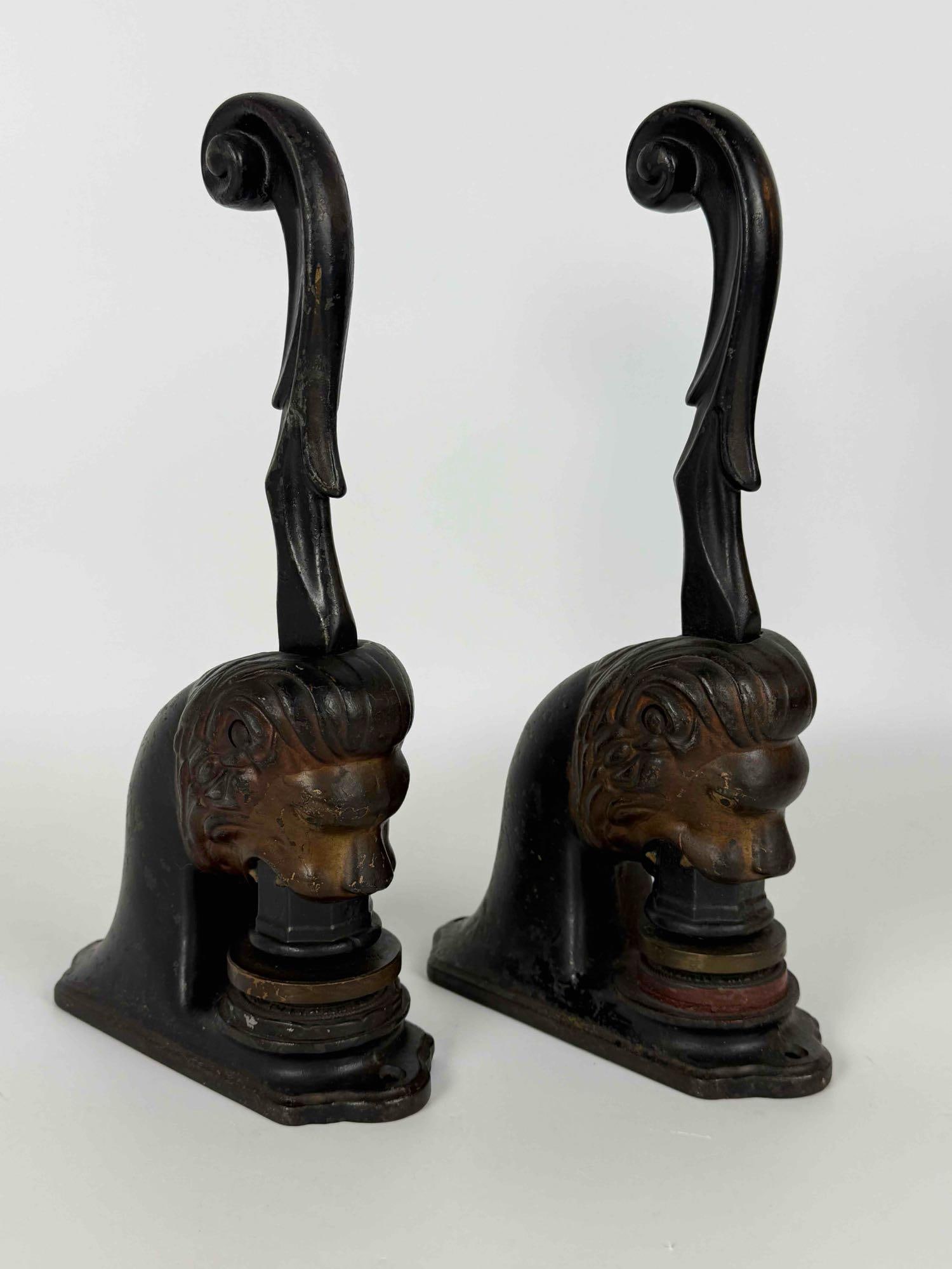 PAIR OF ANTIQUE CAST IRON LION HEAD NOTARY SEALS: Heavyweight black-finished figural cast iron desk embossers featuring highly detailed relief-molded lion head housings and long-reach curved lever handles. Approximate Dimensions: 11”H x 2.5&rdq