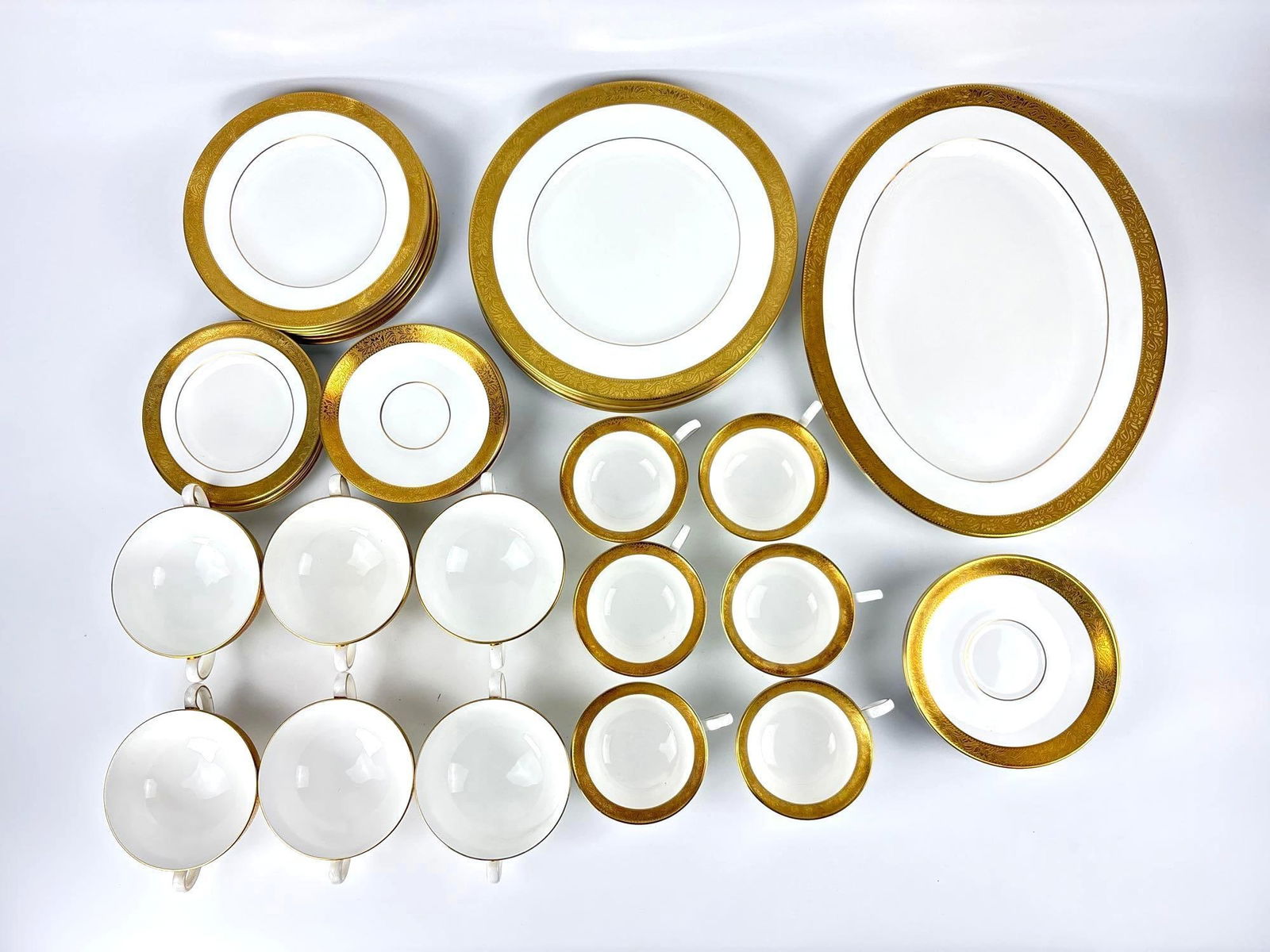 WEDGWOOD ASCOT BONE CHINA DINNER SERVICE 41 PIECES: Elegant fine bone china collection with raise gold encrusted borders and gold trim. Approximate Dimensions of largest: 15.5" x 12" Artist or Maker: Wedgwood Provenance: From a New York Collect