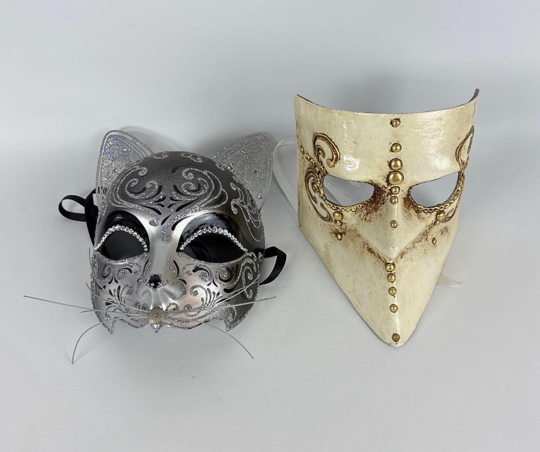VINTAGE SET 2 HAND DECORATED VENETIAN MASQUERADE MASKS: Two papier-mache masks pieces from Casanova Venezia and The Art of Masks, workshops in Venice, Italy, including a silver-leafed "Gatto" and an ivory-toned "Medico della Peste" with gold accents. Appr