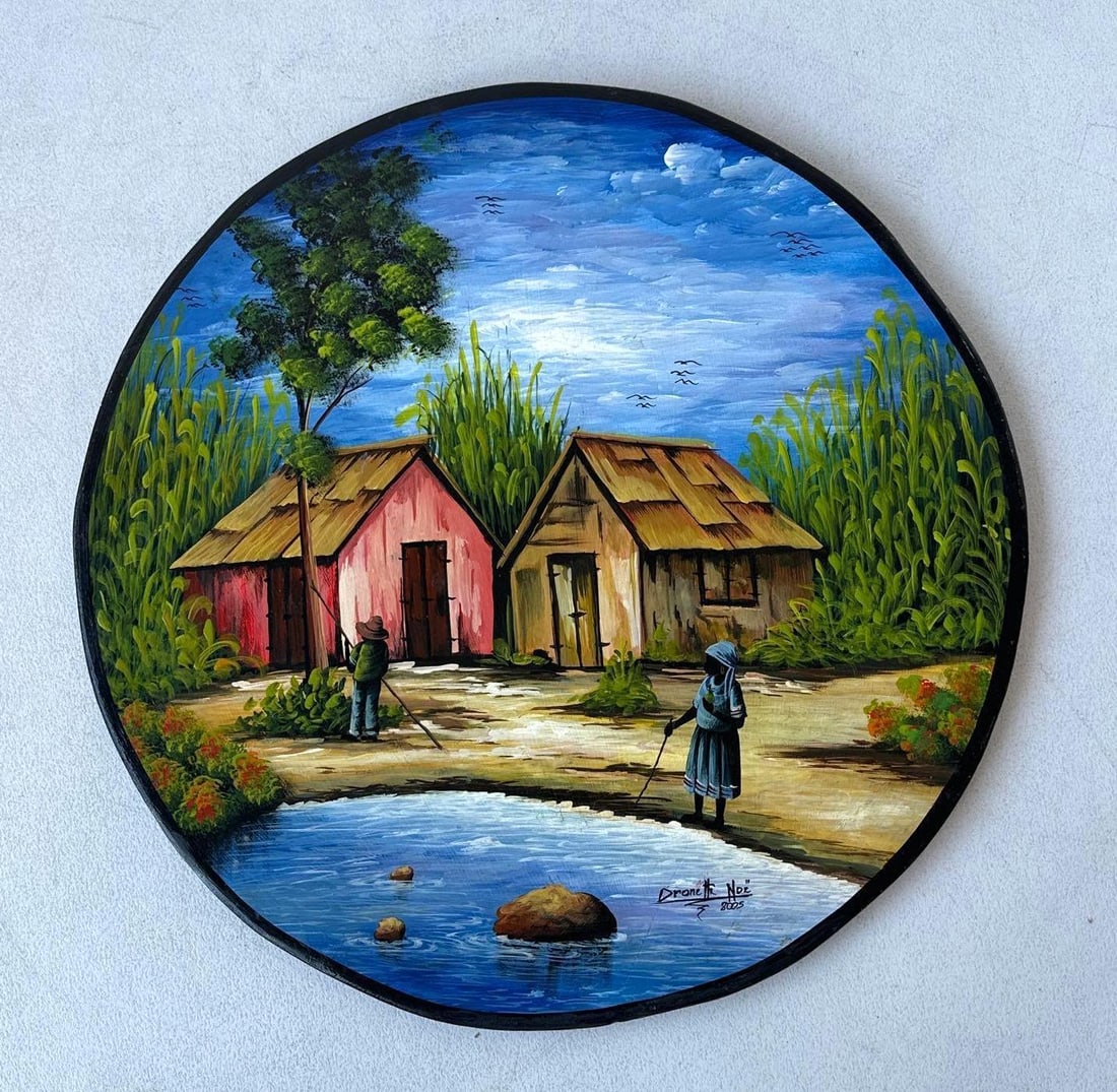 HAITIAN FOLK ART PAINTING ON WOOD, SIGNED DRONETTE NOE: An original Haitian folk art round oil painting on wood, featuring a vibrant village scene. Approximate Dimensions: 27" DIA Artist: Dronette Noe Provenance: A New York Collector Notes: Alt