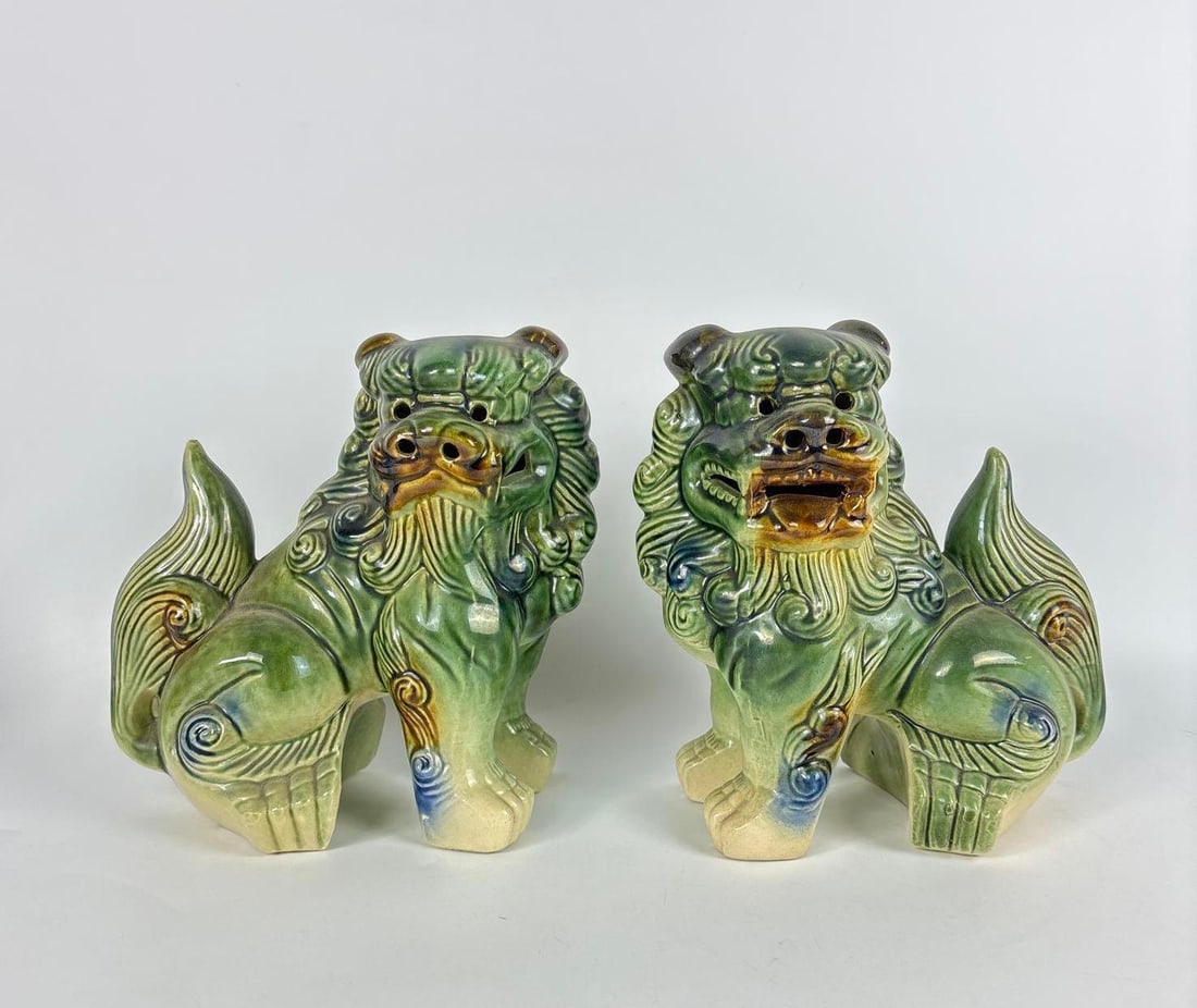 PAIR OF VINTAGE CHINESE GLAZED CERAMIC FOO DOG GUARDIAN LIONS: Matched duo of traditional hand-painted Asian temple lion sculptures finished in a vibrant green glaze. Approximate Dimensions: 8.5" x 5" Artist or Maker: Unknown Provenance: From a New York Collecto