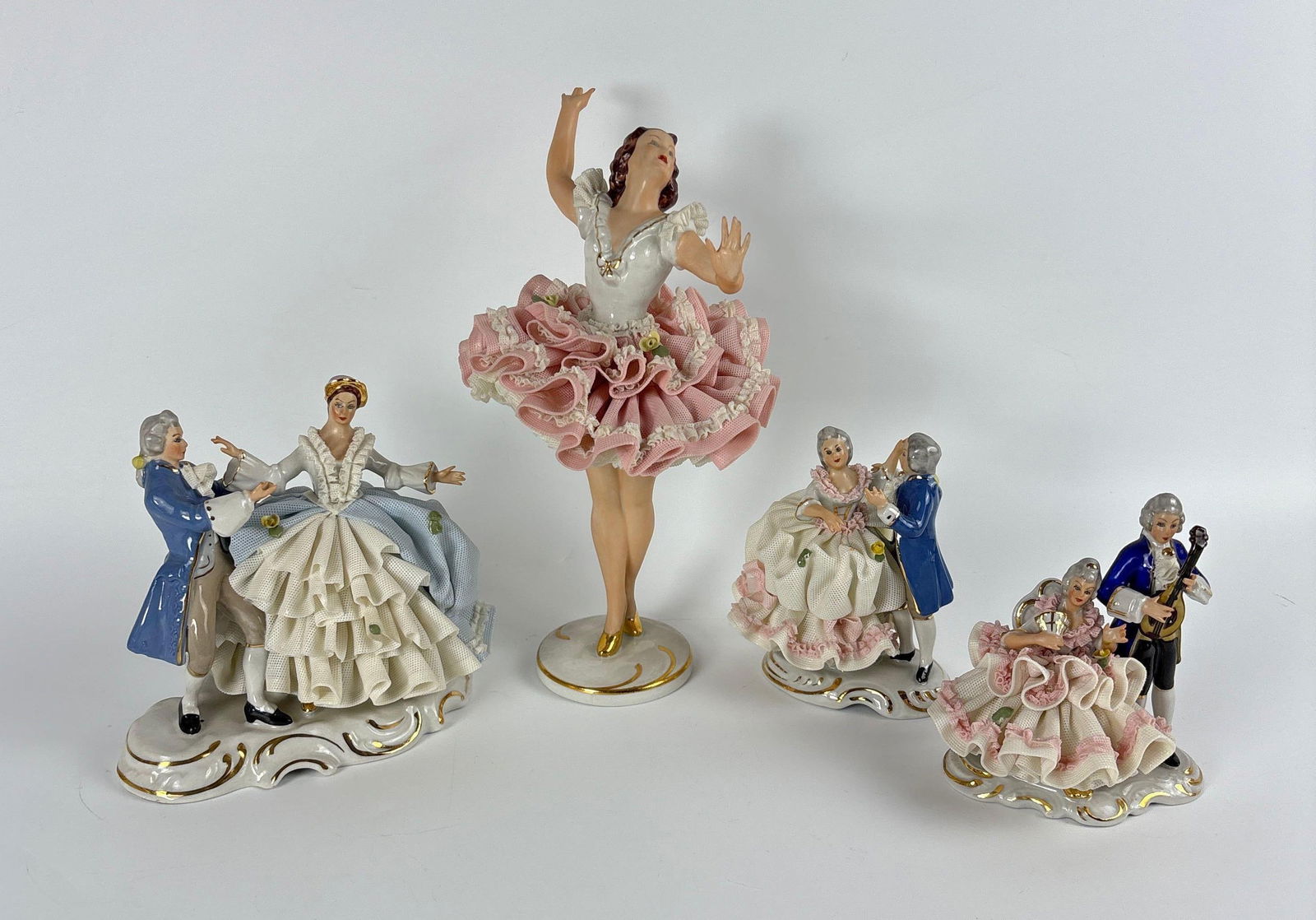 SET OF 4 VINTAGE DRESDEN GERMANY LACE PORCELAIN FIGURINES: Four hand-painted Dresden porcelain figurines including a ballerina and 18th-century courting couples with intricate lace detailing. Approximate Dimensions: Largest 9" x 4.5" Artist or Maker