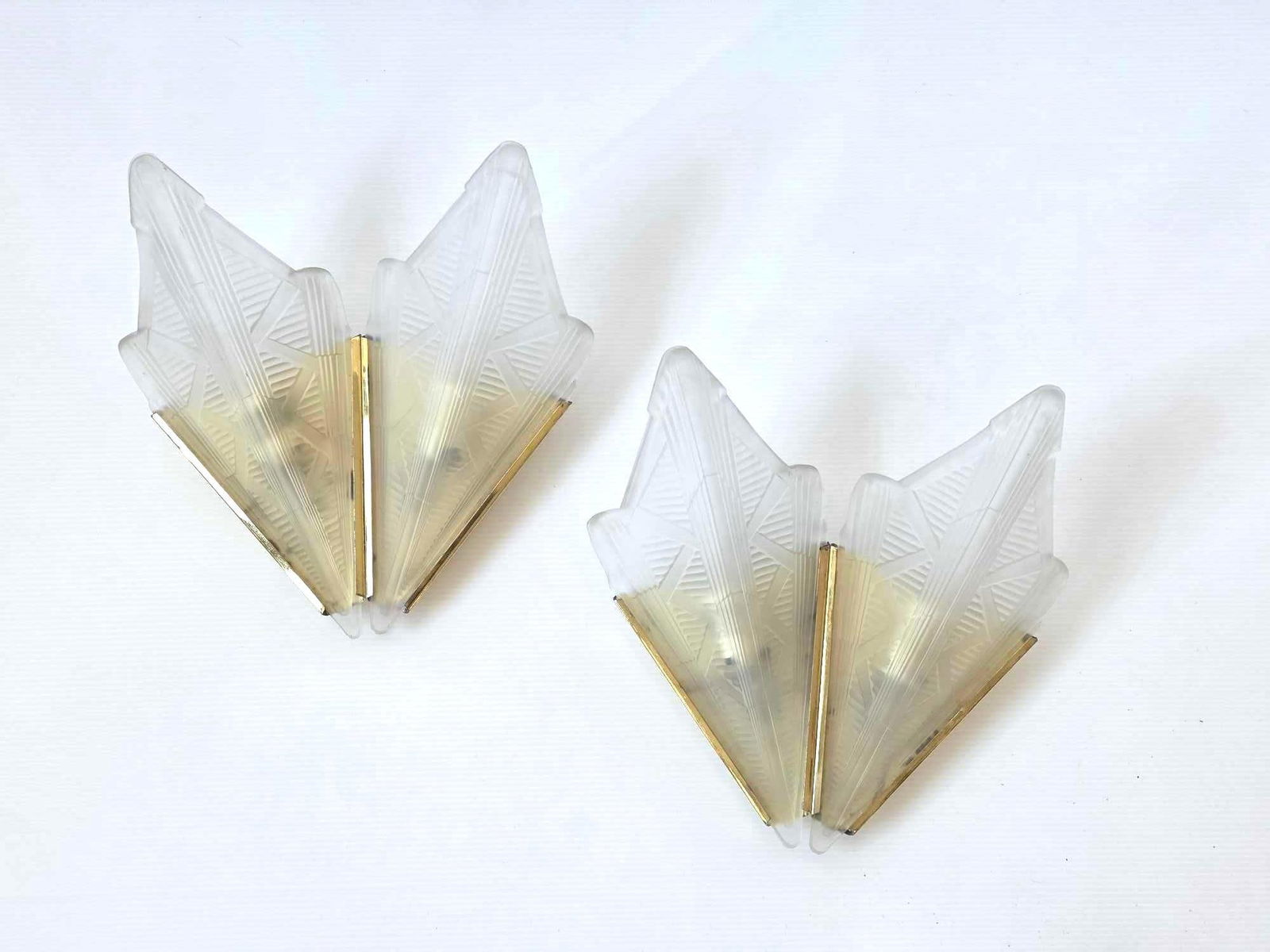 PAIR OF ART DECO STYLE BRASS AND FROSTED GLASS TWO LITE SCONCES: *Pair of french art deco frosted glass and metal wall sconces- fan shape, 1920's Dimensions: 12"h x 11.5"w x 5.5"d Maker: Unknown Notes: Although care is taken to photograph and describe the item, a
