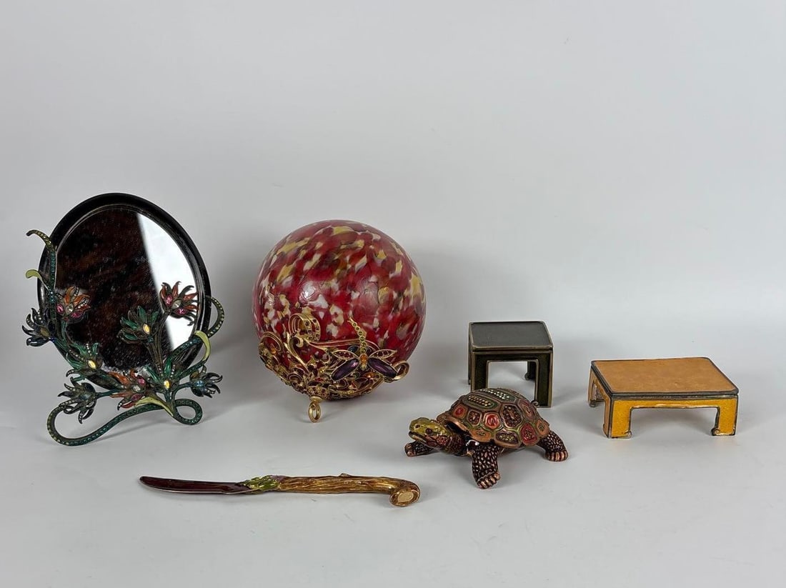 JAY STRONGWATER ENAMELED & CRYSTAL ACCENTED DECORATIVE OBJECTS, GROUP OF 6: Collection of handcrafted enameled metal accessories adorned with Swarovski crystals including a floral vanity mirror, dragonfly ornament, turtle box, letter opener, and two miniature pedestals. Appr
