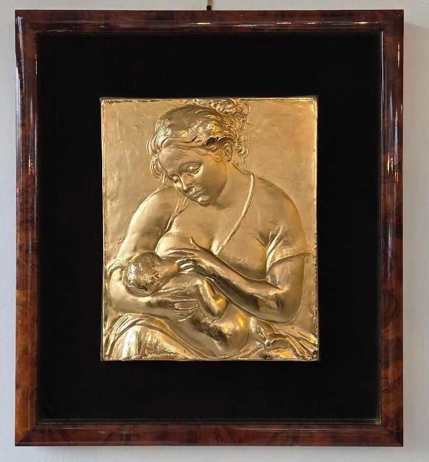 FRANCESCO MESSINA BRONZE/GILT-BRONZE BAS-RELIEF FRAMED SCULPTURE, MATERNITA (MOTHER AND CHILD): *A framed bronze or gilt-bronze bas-relief sculpture plaque depicting a mother breastfeeding a child (Maternita), executed in the Italian Figurative / Novecento style by Francesco Messina (1900–1995