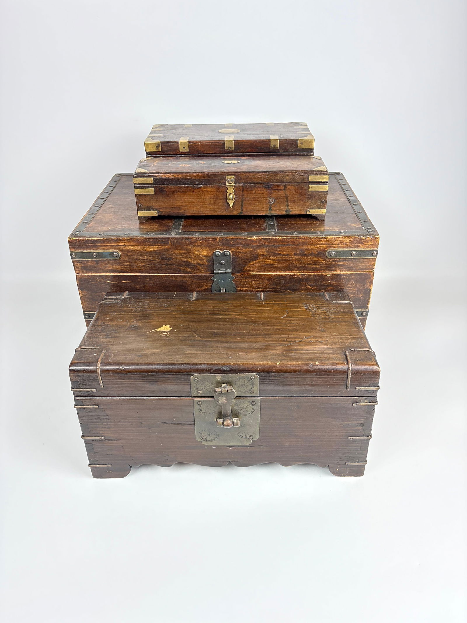 ANTIQUE STACKING WOODEN CHEST TRUNK WITH BRASS HARDWARE SET OF 3: *Antique storage cabinet trunk set Dimensions: 16" x 11" Maker: Unknown Provenance: A New York Collector Notes: Although care is taken to photograph and describe the item, absence of a
