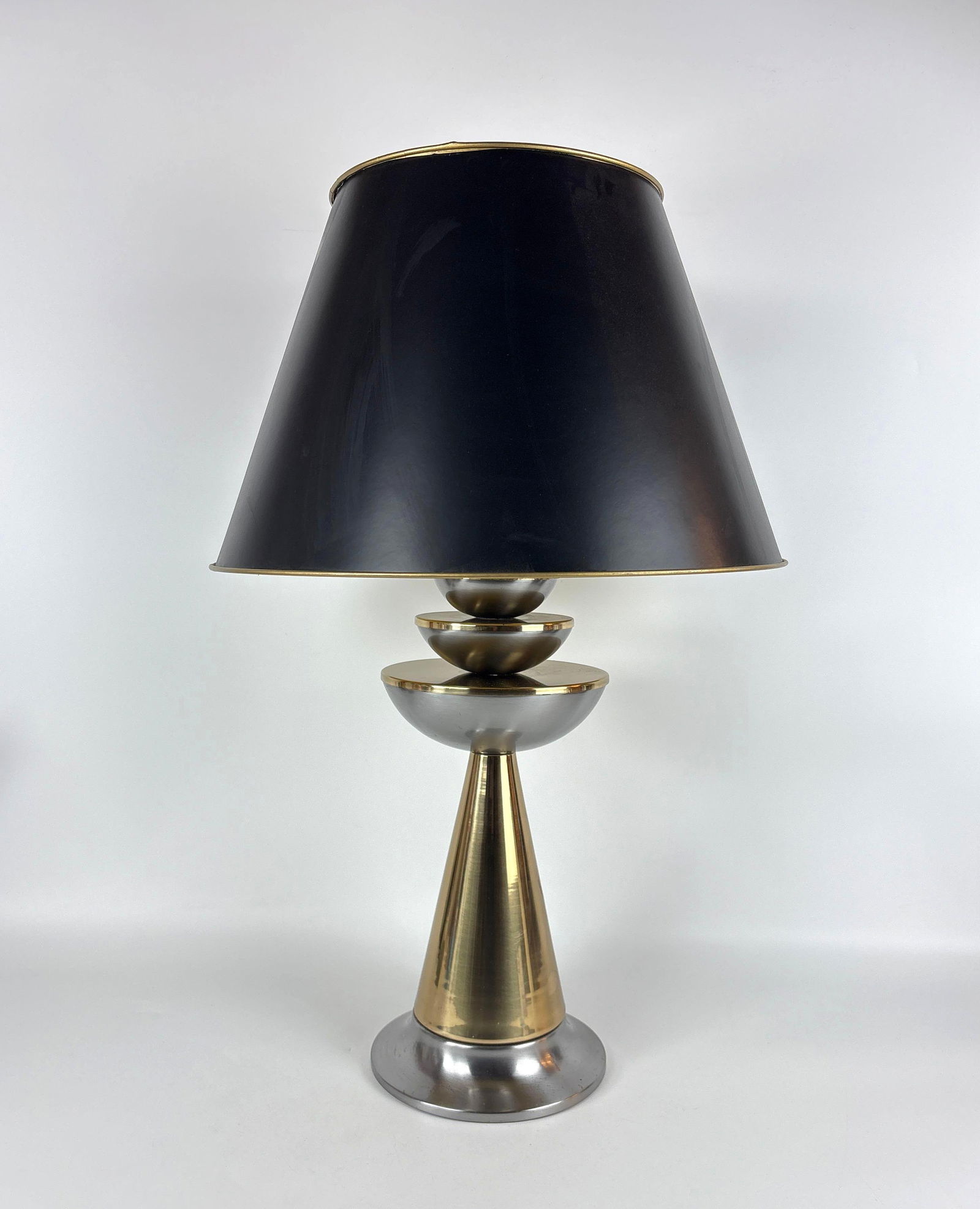 LAUREL STYLE MID-CENTURY MODERN STACKED METAL TABLE LAMP SPACE AGE DESIGN: A stacked, mid-century modern lamp with mixed metal tones, topped with a black shade not original to lamp by Artemis Studios. Approximate Dimensions: 30"H x 8"DIA (shade 17"DIA) Artist or Maker: Unk