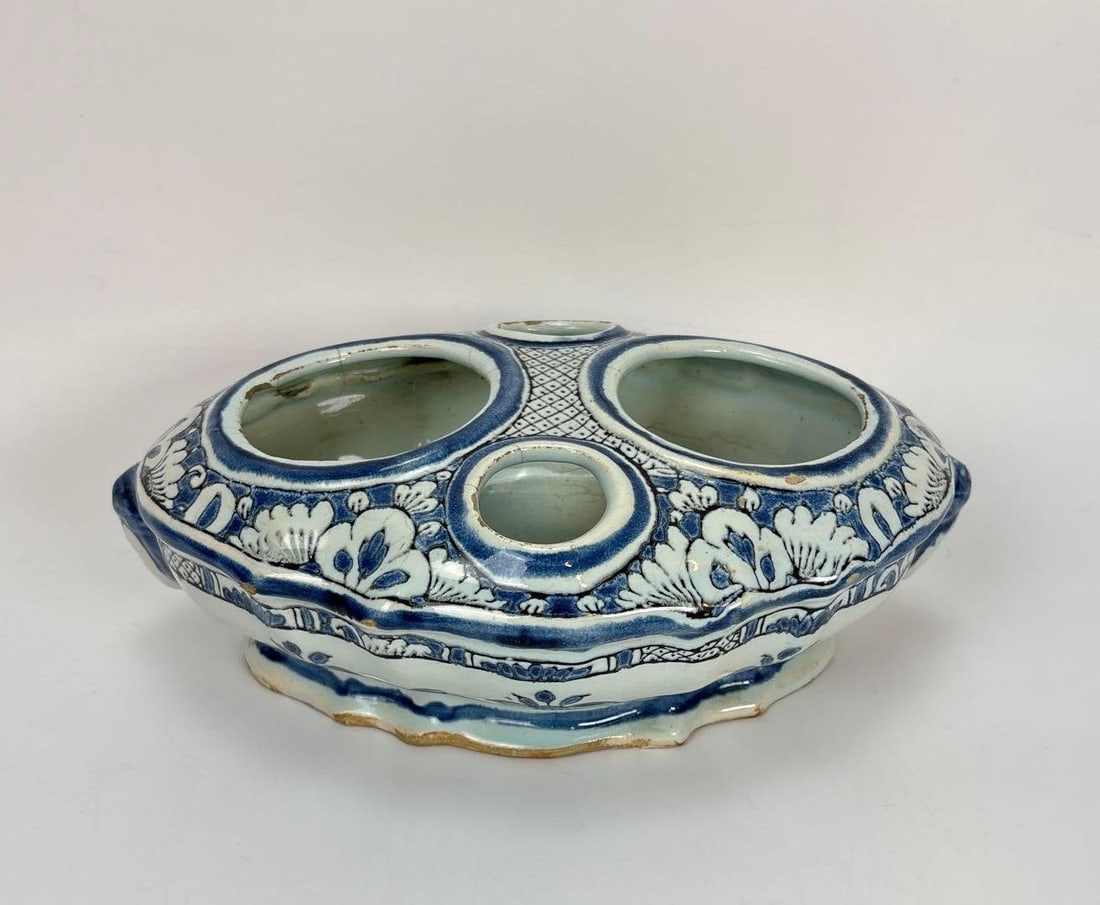 (4) RARE ANTIQUE DELFT OVAL SCALLOPED CRUET STAND: A scalloped oval tin-glazed earthenware stand with fluted and lobed sides, four circular openings, and flanking masqueron handles. Approximate Dimensions: 3.5" x 10" x 7" Artist or Maker