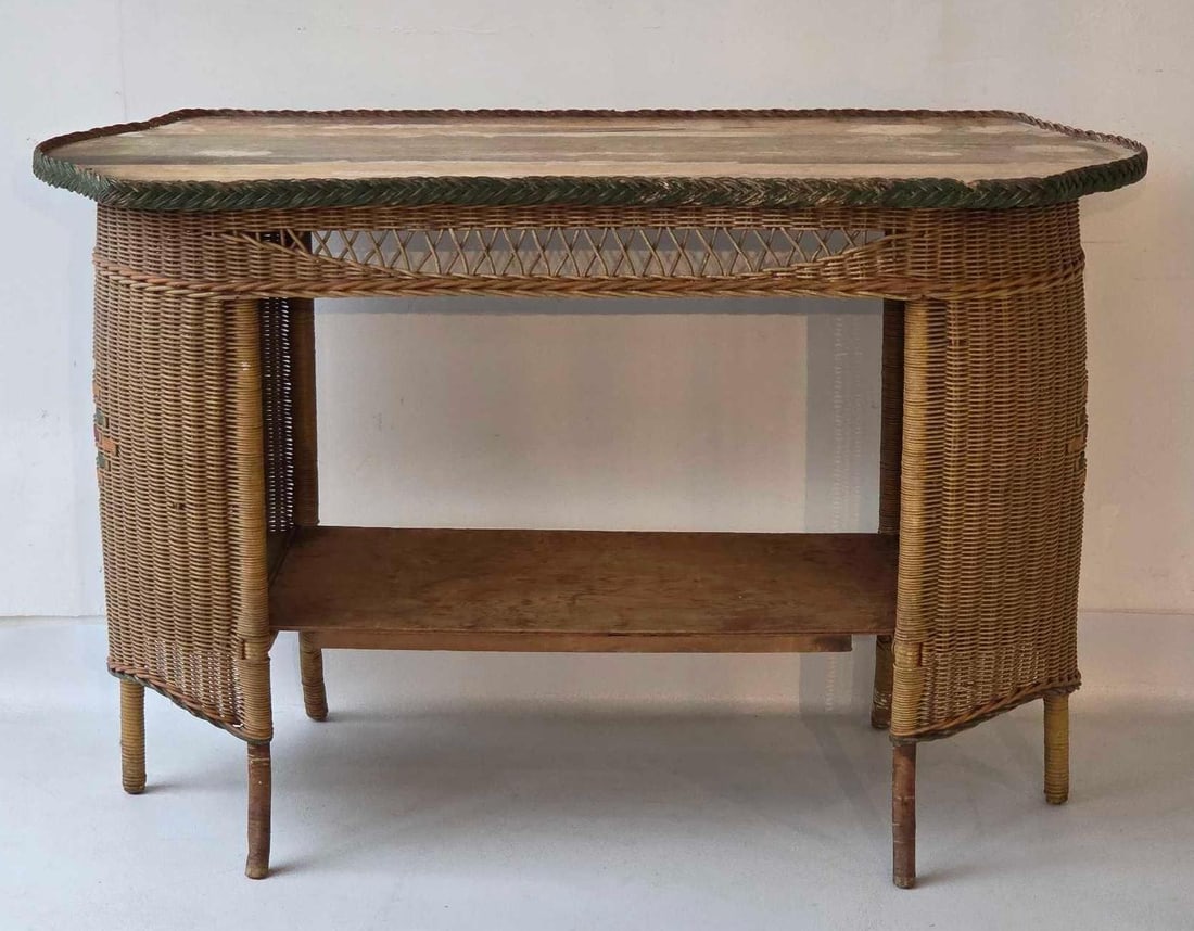 ANTIQUE BAR HARBOR STYLE WICKER CONSOLE TABLE: Antique woven wicker console table with diamond medallion inlay, braided green trim, and lower wood shelf. Approximate Dimensions: 31"h x 48.5"w x 18.5"d Artist or Maker: Unknown Proven