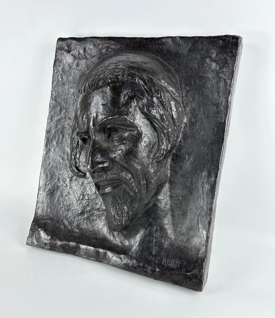 CLARA BRATT JUDAICA BRONZE RELIEF PLAQUE: A cast bronze high-relief wall plaque portrait of a rabbi, signed. Approximate Dimensions: 19” x 16” x 6" Artist: Clara Bratt Provenance: A New York Collector Notes: Althoug
