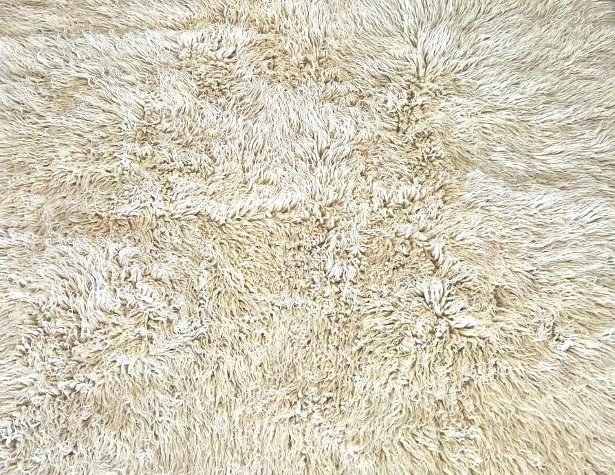 VINTAGE FLOKATI WOOL RUG: A hand-woven, long pile shaggy area rug in natural off-white wool. Approximate Dimensions: 7'10" x 5' Artist or Maker: Unknown Provenance: From a New York Collector Notes: Altho