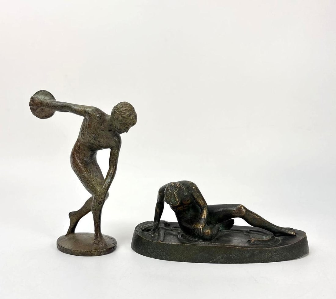 SMALL PATINATED BRONZE DISCOBOLUS AND DYING GAUL, GRAND TOUR FIGURINES: Pair of cast bronze grand tour figures depicting the Greek Discus Thrower and the Roman Wounded Galatian. Largest Dimensions: 5.5" h x 3.5" x 2" Artist or Maker: Unknown Provenance: Fro
