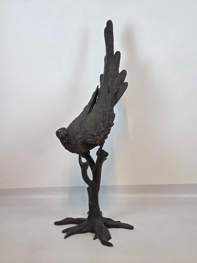 LIFESIZE BRONZE PARROT ON BRANCH SCULPTURE: A life-sized bronze macaw parrot perched on a branch base with a dark patinated finish in the French Art Deco style. Approximate Dimensions: 55"h x 22"w x 21"d Artist or Maker: Unknown