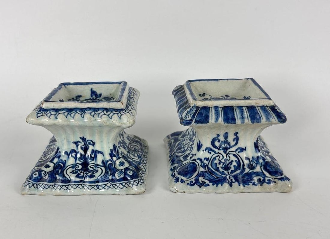 PAIR OF 18TH CENTURY DELFT BLUE AND WHITE TRENCHER SALTS: Pair of tin-glazed earthenware salt cellars with flared gadrooned borders and floral scroll motifs, marked "o w" over 3 and 0 Approximate Dimensions: 2" x 3" x 3" Artist or