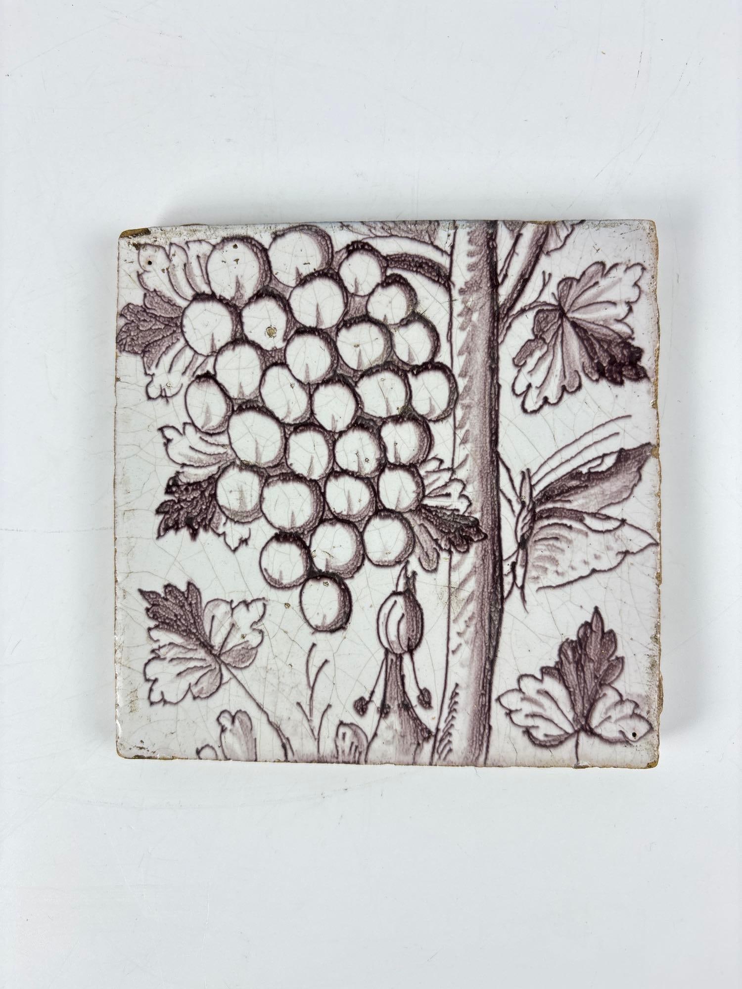 ANTIQUE BROWN AND WHITE FAIENCE CERAMIC TILE WITH GRAPE AND BUTTERFLY MOTIF (1 of 3)
