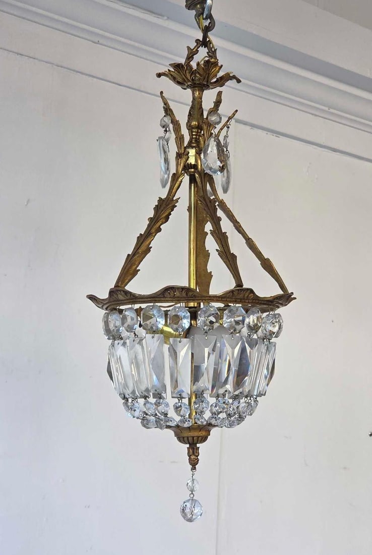 PETITE BRONZE AND CRYSTAL BASKET CHANDELIER: *A petite French Empire-style basket chandelier featuring a cast gilt frame with cascades of cut crystal bead chains and faceted prisms. The "sac a perles" (bag of pearls) design includes a de