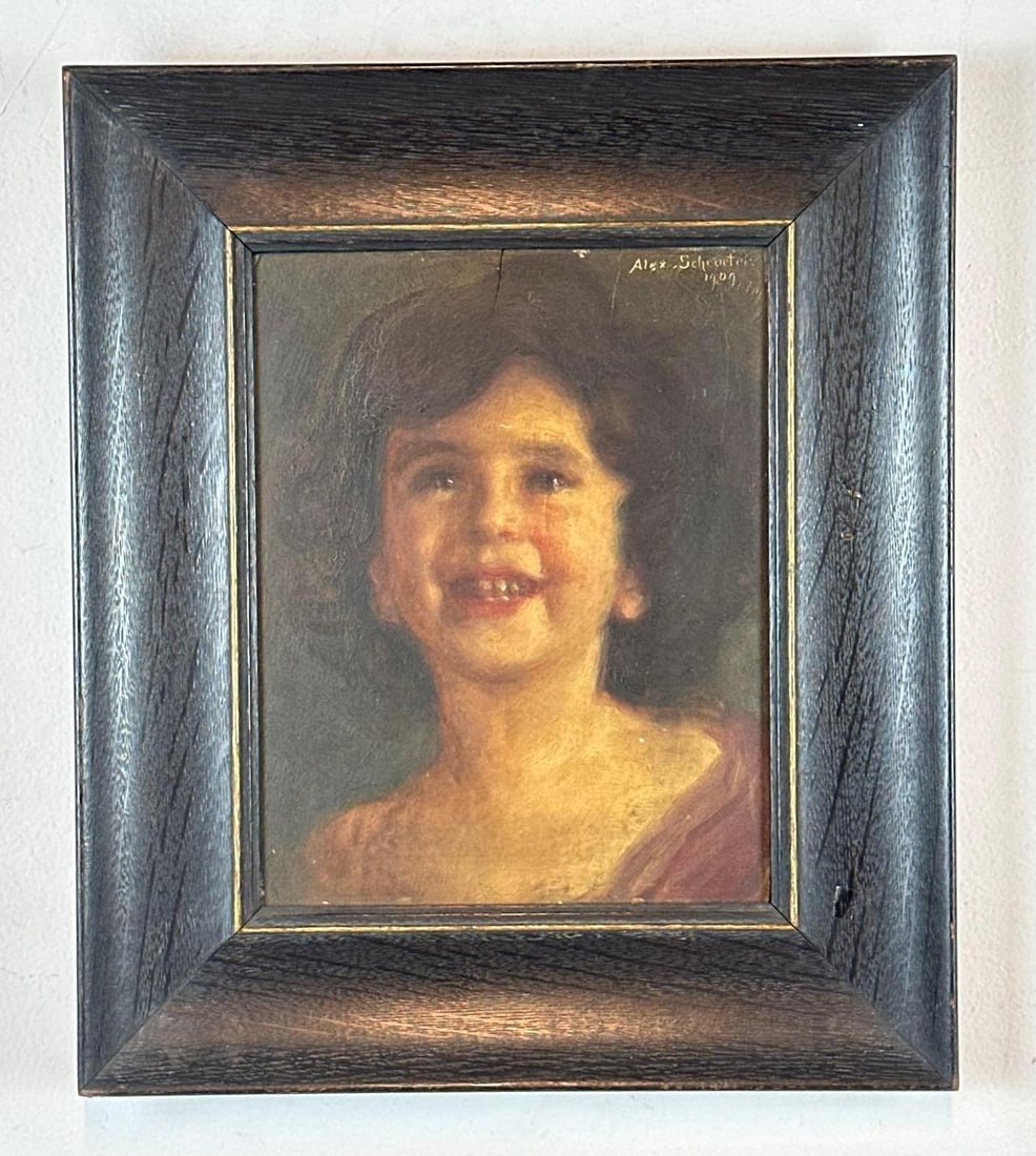 ALEX SCHROETER 1907 ANTIQUE OIL PORTRAIT OF A SMILING CHILD: Original oil on board painting depicting a joyful young child with dark curly hair housed in a wide dark wood frame with gilt liner. Approximate Dimensions: 10” X 8”; Frame 16” X 13.