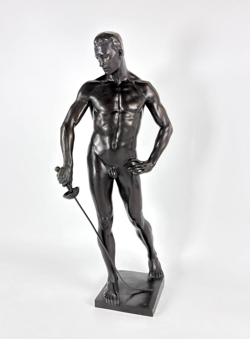 HUGO LEDERER SIGNED BRONZE SCULPTURE THE FENCER "DER FECHTER": Bronze athletic male nude figure in a classical contrapposto stance holding a fencing foil on a square integral plinth. Approximate Dimensions: 21"h Artist or Maker: Hugo Lederer Provenance: Fr