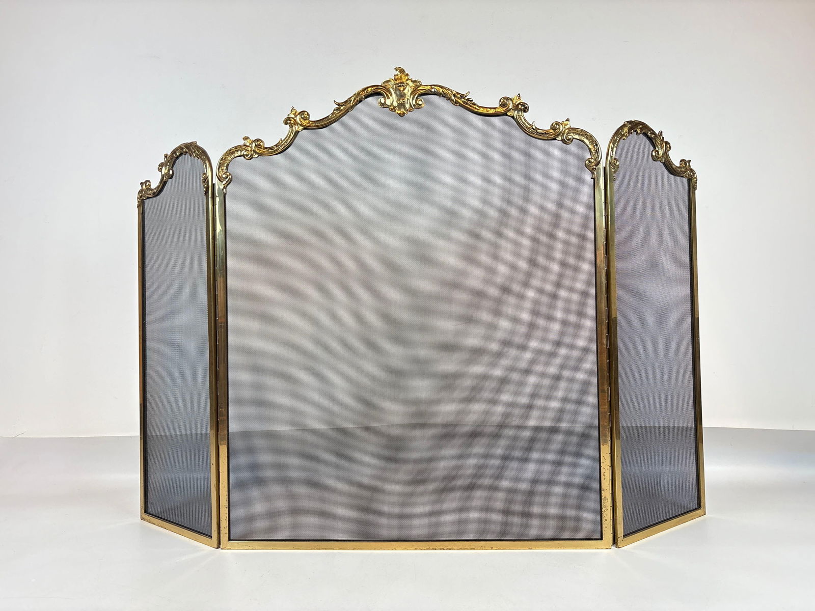 WILLIAM H. JACKSON FRENCH-STYLE THREE-PANEL GILT METAL FIRESCREEN: *Tri-fold mesh hearth protector with ornate gold-toned metallic frame Approximate Dimensions: 37" h x 55" x .5" Artist or Maker: William H. Jackson Provenance: From a New York Collecto