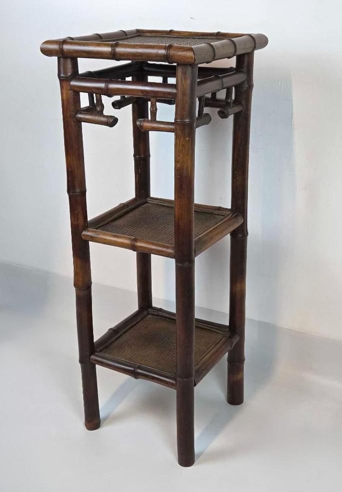 VINTAGE THREE TIER BURNT BAMBOO AND RATTAN ETAGERE DISPLAY STAND: *Triple level architectural plant stand with tortoiseshell finish bamboo frame and woven rattan shelving surfaces. Approximate Dimensions: 39.75"h x 15"w x 15"d Artist or Maker: Unknown Pr