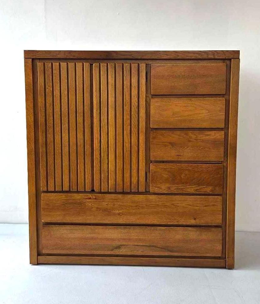 VINTAGE MID-CENTURY MODERN GENTLEMAN'S CHEST WITH SLATTED DOORS: A large armoire dresser with vertical slatted cabinet doors with six drawers. Approximate Dimensions: 47"H x 45"W x 18"D Artist or Maker: Unknown Provenance: From a New York Collector