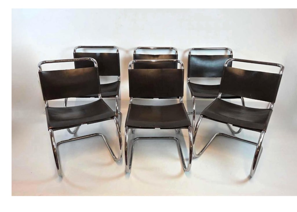 EXCEPTIONAL SET OF SIX VINTAGE LEATHER AND STEEL CANTILEVER CHAIRS IN THE STYLE OF MIES VAN DER ROHE: Mid-century modern tubular chrome cantilever chairs with black leather sling seats Approximate Dimensions: 31"h x 19.25"w x 26"d Artist or Maker: Unknown Provenance: From a New York Colle