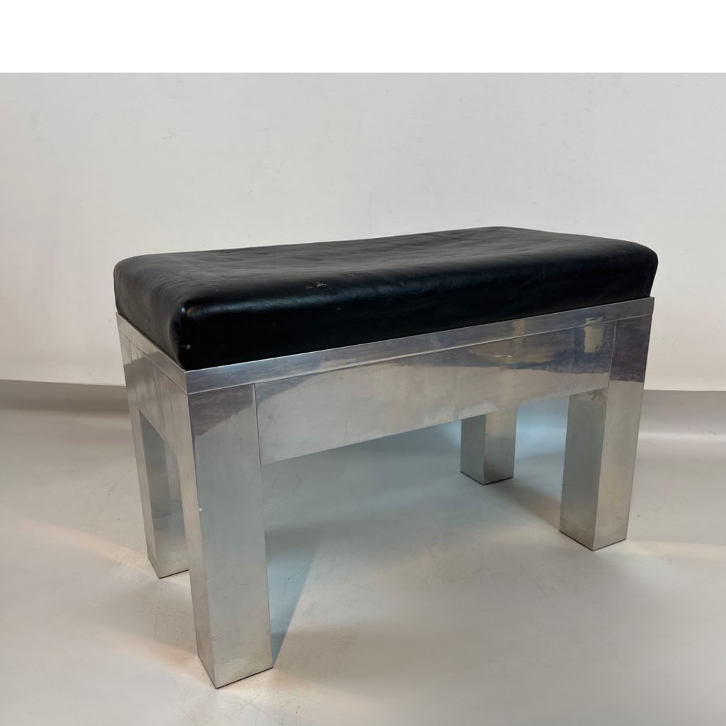 VINTAGE MODERNIST ALUMINUM & LEATHER OTTOMAN BENCH: Mid-century modern compact bench (30") featuring a deep-tufted black leather cushion on a polished aluminum base. Approximate Dimensions: 19”h x 28”w x 14”d Artist or Maker: Unkn