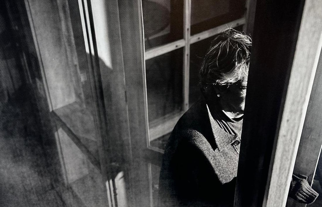 MOUNTED CONTEMPORARY BLACK AND WHITE PHOTOGRAPH OF FIGURE IN DOORWAY: Large-format monochromatic fine art photograph mounted on board depicting a candid high-contrast profile of a person partially obscured by a door frame in a sunlit interior Approximate Dimensions: Dim