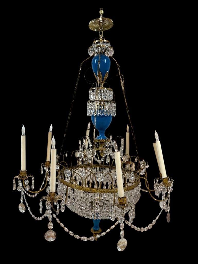 EXCEPTIONAL RUSSIAN LOUIS XVI STYLE BRASS AND BLUE OPALINE GLASS CRYSTAL CHANDELIER: A grand, tiered eight-light neoclassical fixture with blue opaline glass baluster elements and faceted crystal prisms. Approximate Dimensions: 51”H x 31”W x 31”D Artist or Maker: U