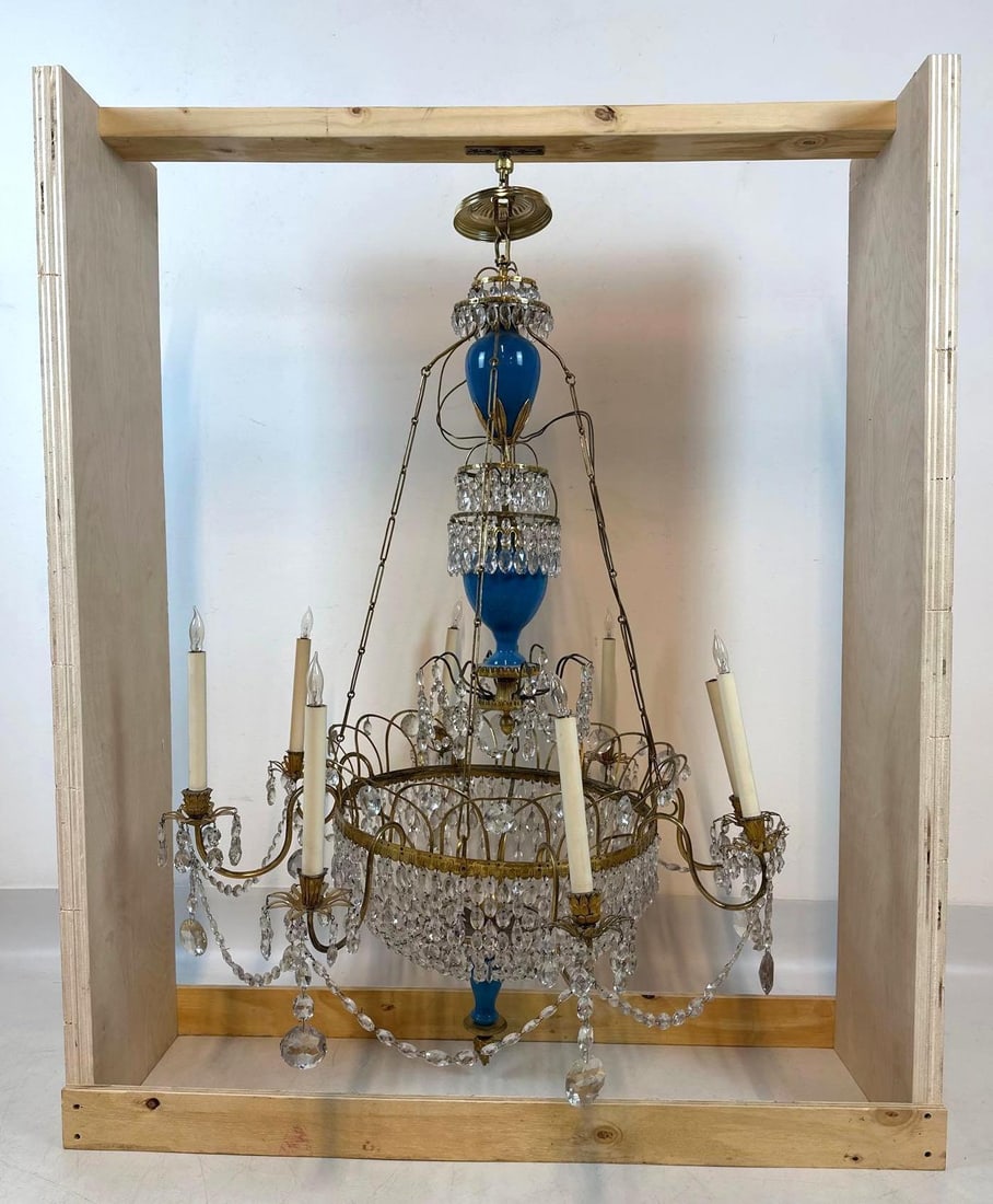 EXCEPTIONAL RUSSIAN LOUIS XVI STYLE BRASS AND BLUE OPALINE GLASS CRYSTAL CHANDELIER: A grand, tiered eight-light neoclassical fixture with blue opaline glass baluster elements and faceted crystal prisms. Approximate Dimensions: 51”H x 31”W x 31”D Artist or Maker: U