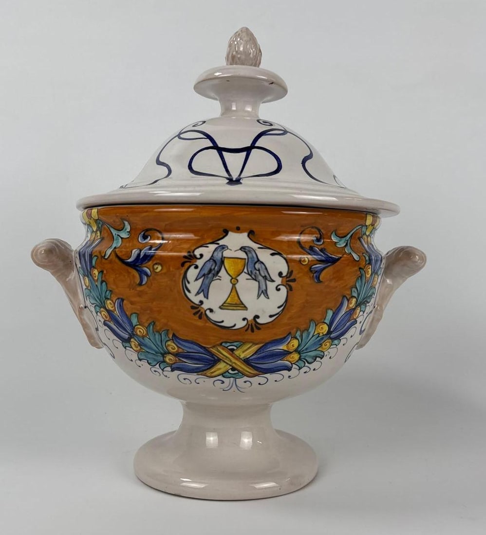 VINTAGE ITALIAN HAND-PAINTED MAIOLICA EARTHENWARE SOUP TUREEN WITH LID: Hand-decorated ceramic pedestal tureen with scrolling handles and lid featuring traditional blue bird and yellow chalice motifs Approximate Dimensions: 12”h x 11”w x 8”d Artist or Ma