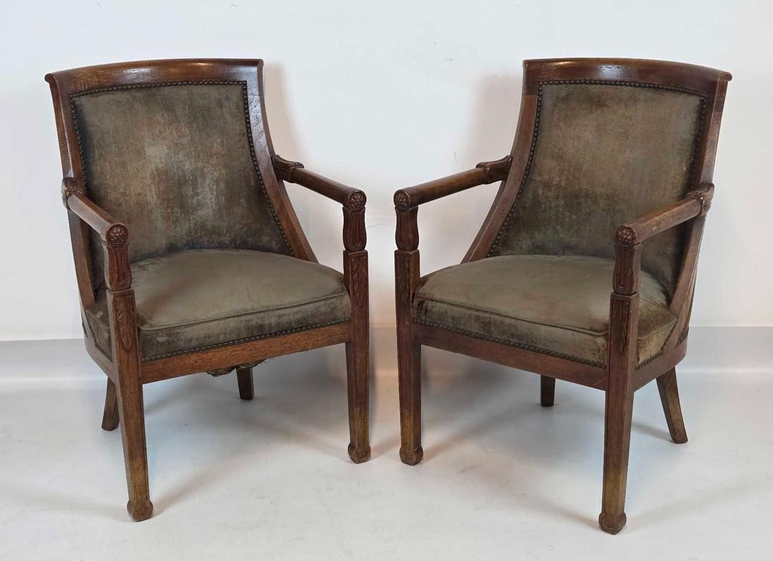 PAIR OF DON RUSEAU FRENCH PROVINCIAL WALNUT ARMCHAIRS: Pair of mid-century hand-carved walnut bergères by Don Ruseau with curved barrel backs, scrolling arms, and Oscar Shadell velvet upholstery accented by decorative nailhead trim. Approximate