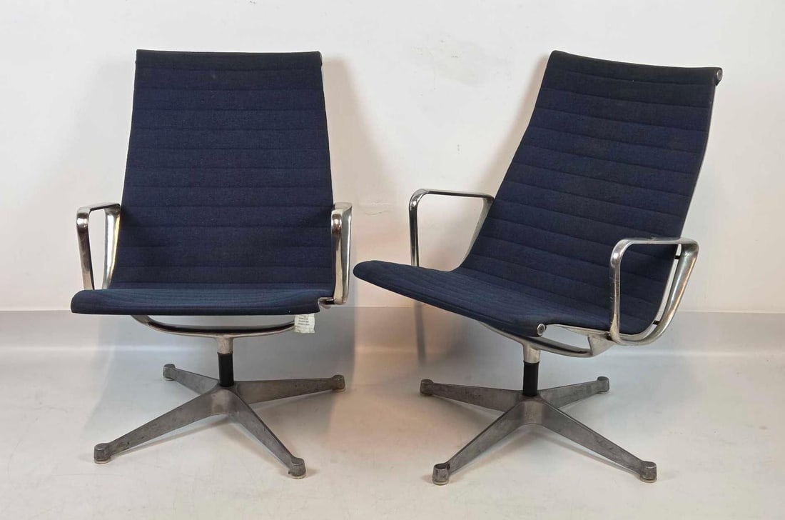 VINTAGE HERMAN MILLER EAMES EA116 ALUMINUM GROUP LOUNGE CHAIRS: High back swivel lounge seating with ribbed black upholstery and polished aluminum four-star base. Approximate Dimensions: Total Height: 34 – 35 inches Width (Arm to Arm): 24.25 – 25 inches 