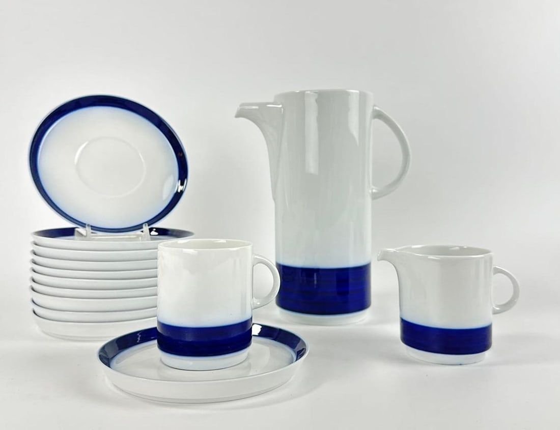 VINTAGE THOMAS GERMANY COBALT BLUE BAND PORCELAIN TEA AND DINNER 40 PC. SERVICE LOT: Mid-century modern white porcelain set with bold cobalt blue horizontal bands including coffee pot, cups, saucers, plates and serving bowls. Aproximately 40 pcs. Approximate Dimensions: Largest 8&rdq
