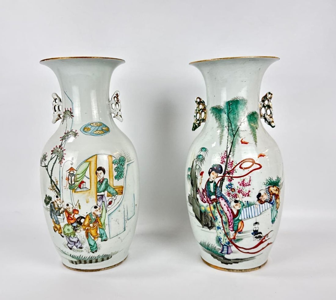 UNUSUAL PAIR CHINESE FAMILLE ROSE PORCELAIN BALUSTER VASES: Matching 19th or 20th-century hand-painted enamel vessels with figural court scenes and pierced butterfly or zoomorphic side handles. Approximate Dimensions: 17”h x 9.5”w Artist or Maker