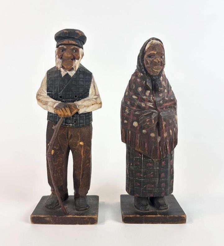 CARL AND N. TRYGG VINTAGE WOOD CARVINGS 1931: Pair of hand-carved and painted wooden folk art figurines depicting an elderly man & woman. Approximate Dimensions: 10.5" x 4" x 3" Artist or Maker: C. Trygg and N. Trygg. Provenance: From a New Y