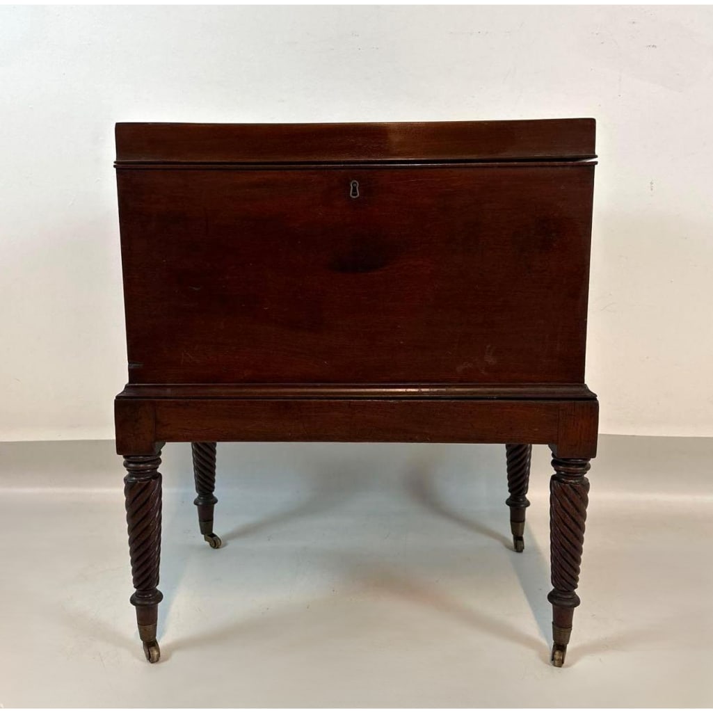 19TH CENTURY MAHOGANY CELLARET: A hand-polished rectangular wine box with hinged lid on base having double-spiral turned legs and brass casters. Approximate Dimensions: 26.5"H x 23"W x 15.5"D Artist or Maker: